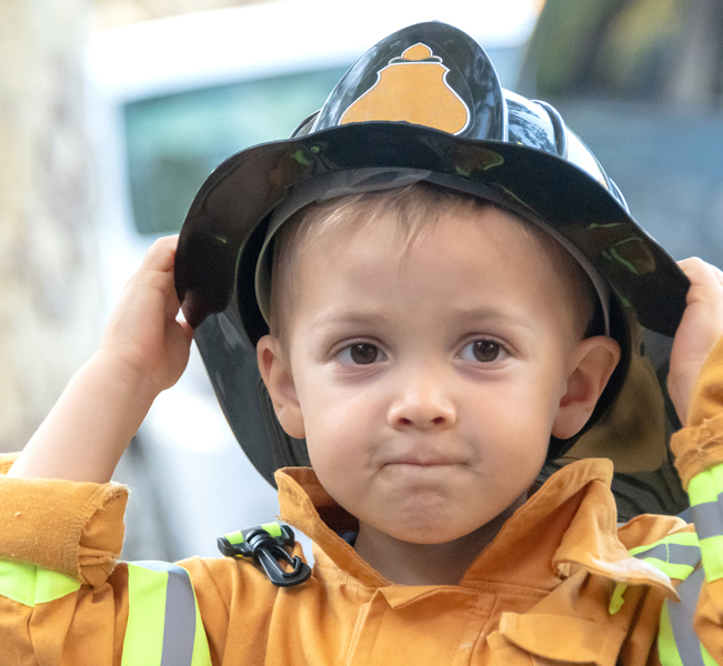 Little boy dressed as firefighter