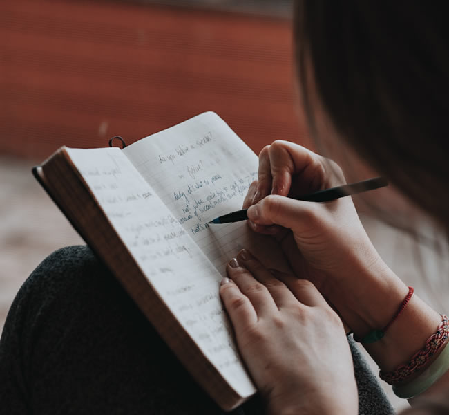 Female teen writing in journal