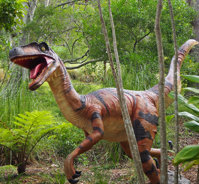 Large brown dinosaur statue outdoors