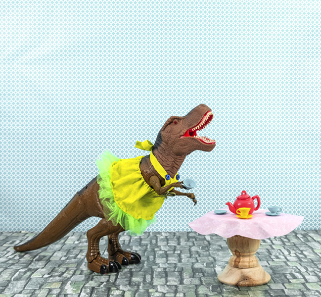 Plastic TRex dressed in apron. Play table & teapot
