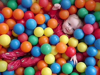 Child in pile of balls